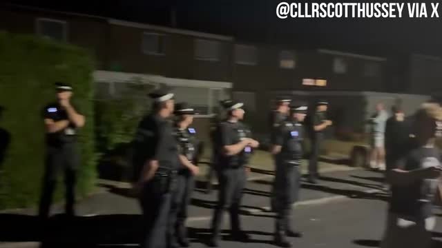 Police guard a Home Office HMO thought to be housing male migrants in Thetford