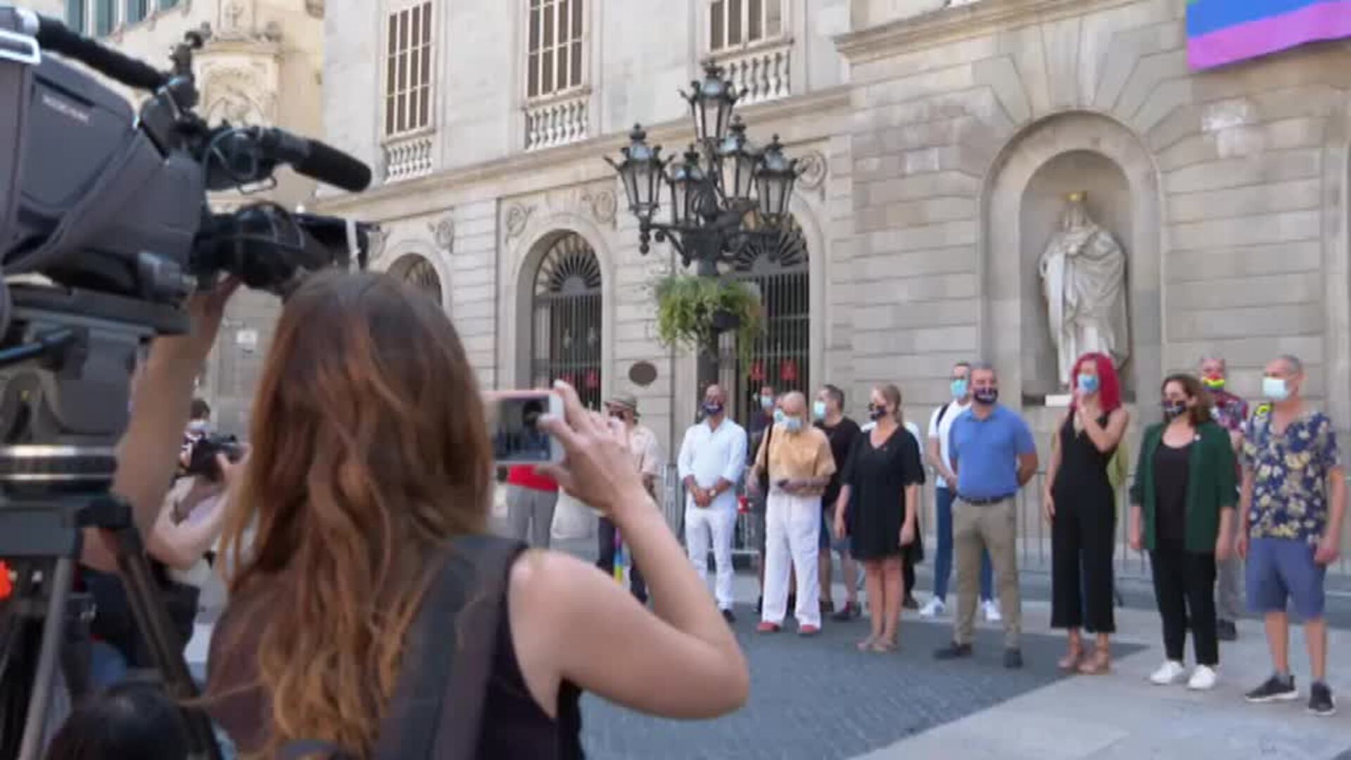 La bandera LGTBI ondea a modo de pancarta en la fachada del Ayuntamiento de Barcelona