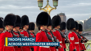 Troops march over Westminster Bridge and past parliament