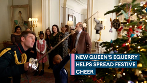 Ceremonial swords help children decorate Christmas tree at Clarence House