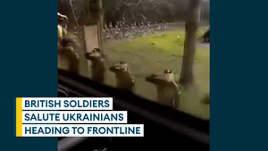 British Army troops salute Ukrainian soldiers as they head to the frontline