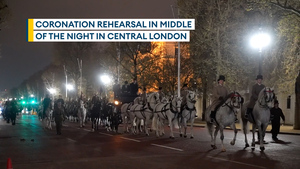 Military parade through London streets on midnight coronation rehearsal