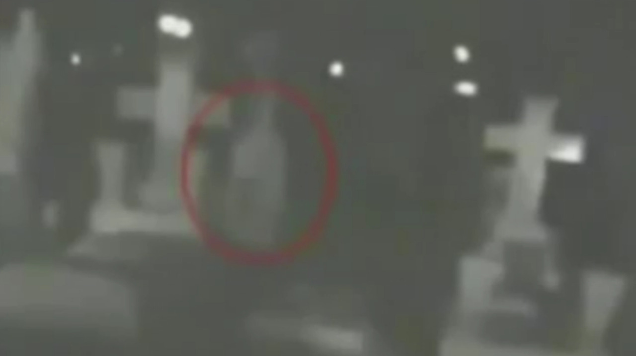 Chilling footage of 'ghost' captured on camera wandering past gravestones in cemetery at night | The Sun