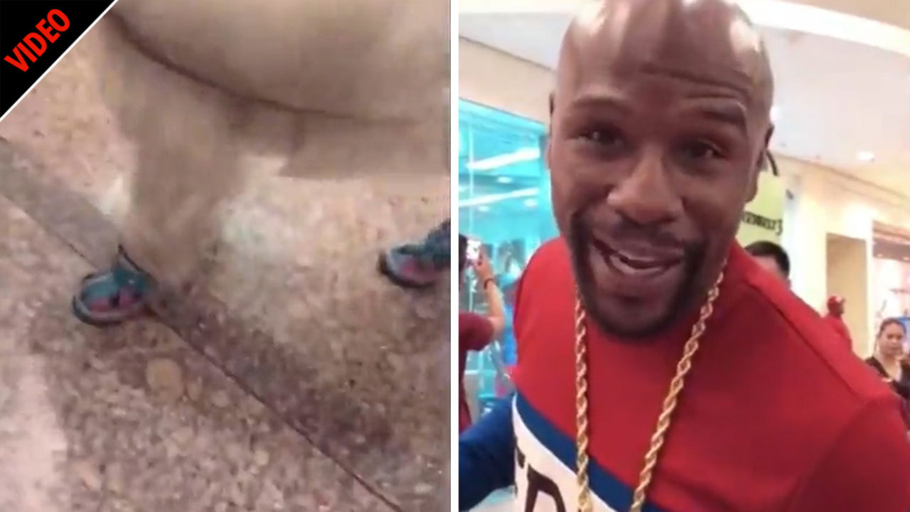 Floyd Mayweather shows off huge wads of cash during shopping spree