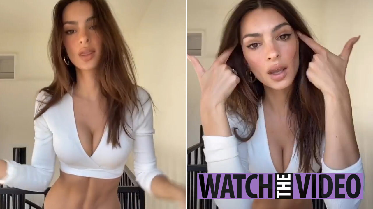 Emily Ratajkowski poses in a thong bikini in bed – watched by