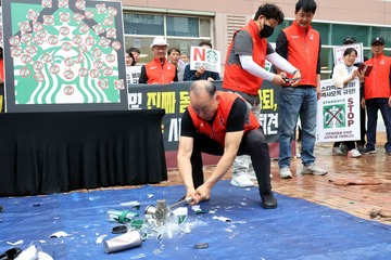 South Korean activists smash Starbucks cups to protest ‘Tank Day’ campaign