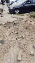 Craters in streets and buildings damaged after air attack on Israel 