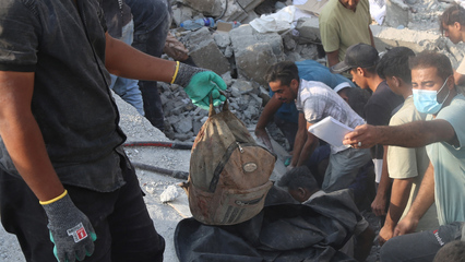 Man accuses Israel of war crimes as he holds remains of girl killed in Iran school attack