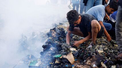 Palestinians search charred remains of Rafah tent camp