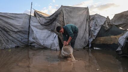 Palestinians suffer flooded tents and debris as cold and rain lash Gaza