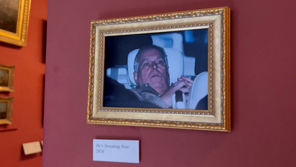 Activists hang Andrew arrest photo at Louvre Museum