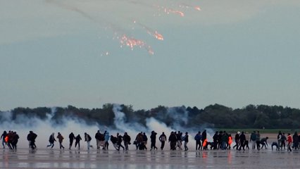 French police fire tear gas at migrants on beach