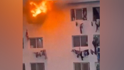 People climb from windows of burning campus building in Dakar