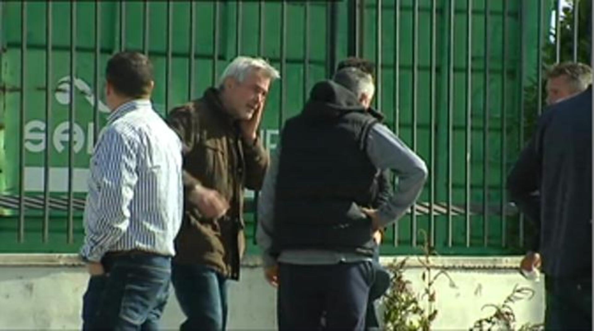 Los cuerpos de los dos fallecidos, cubiertos con sábanas ante la planta incendiada