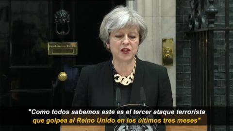 Un policía escuchaba atentamente a Theresa May durante su comparecencia