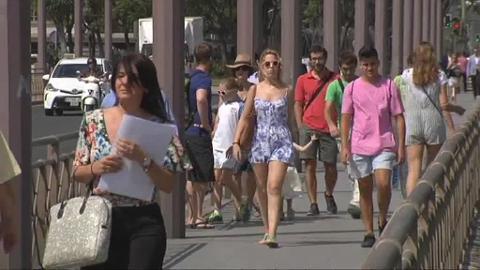 Un turista se refresca en la fuente de la Plaza de España