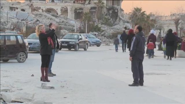 Alguans zonas deAlepo recuperan poco a poco la normalidad. Al fondo, dos retratos de Bascha al Assad y Putin