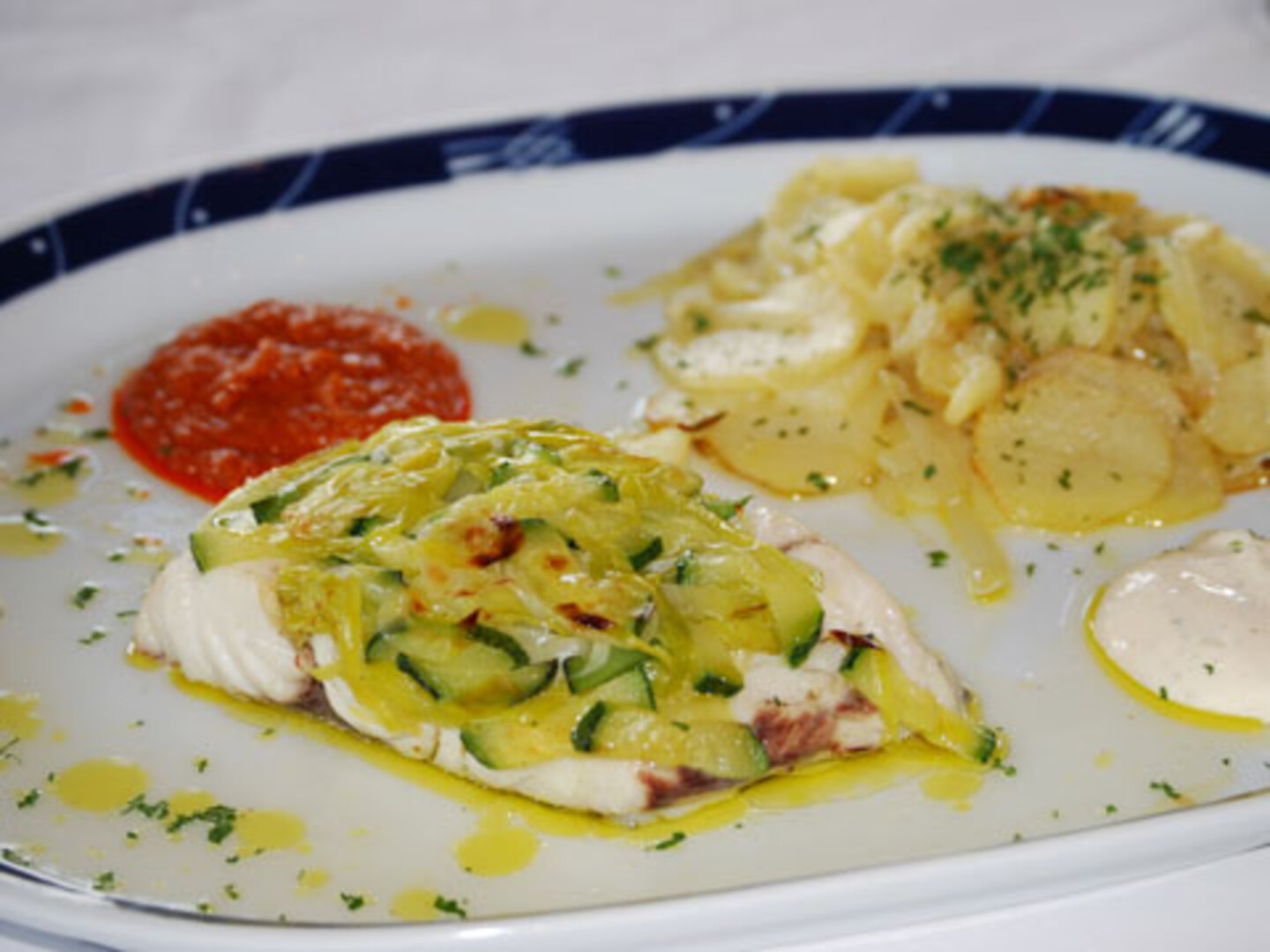 Papillote de lomo de corvina y verduritas con patatas panaderas y dos salsas